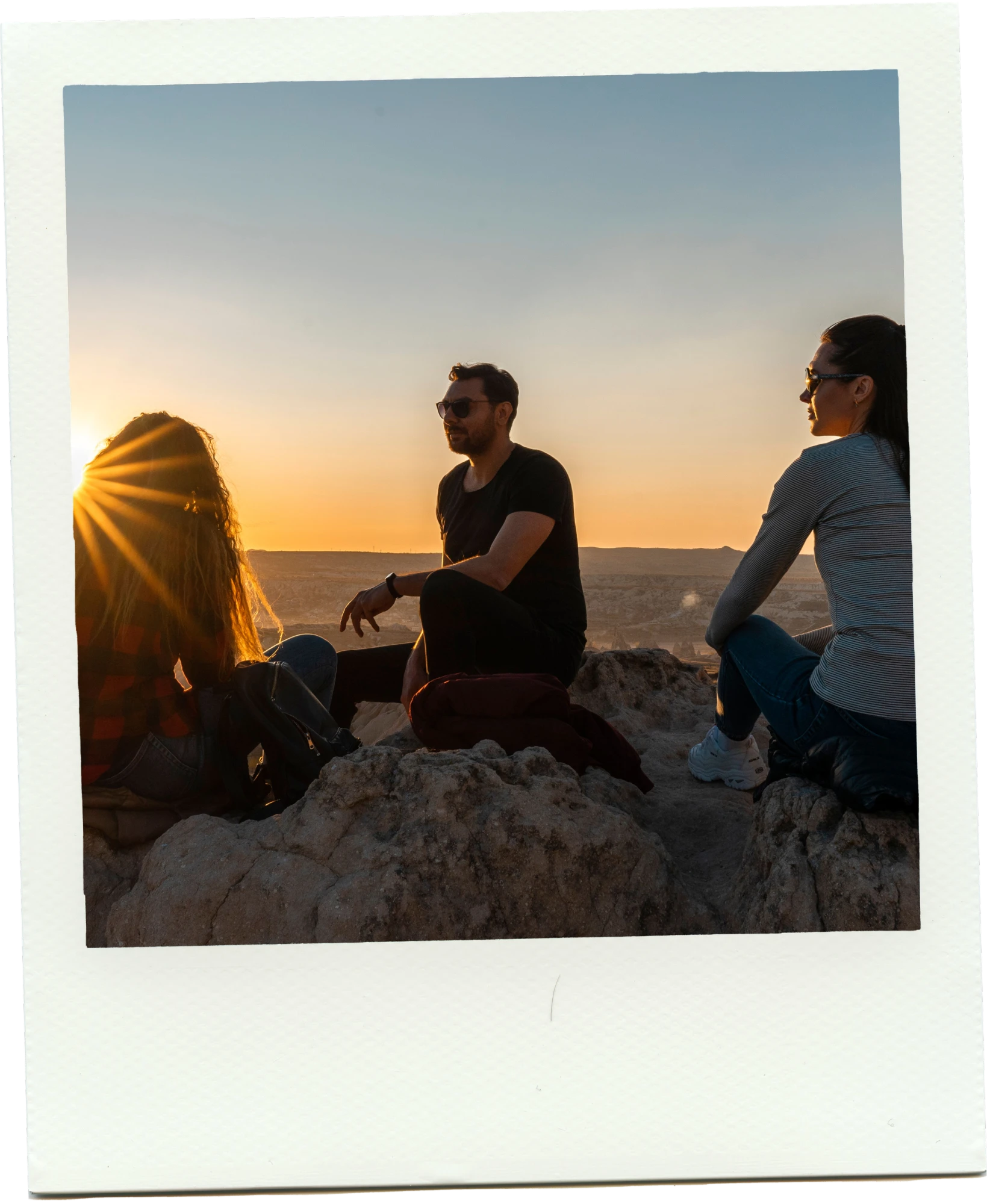 Friends watching the sunset from the rocks